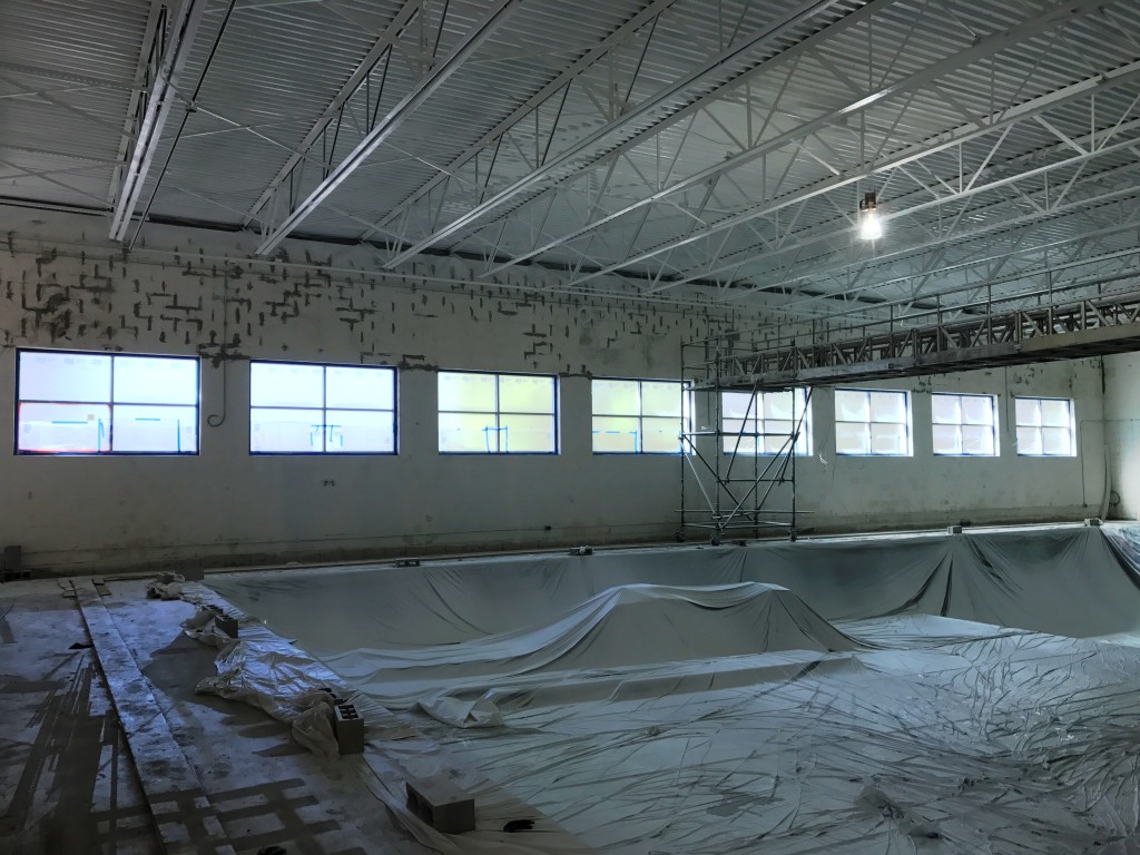 New windows in the renovated swimming pool really brighten up the room. A first coat of paint has also been applied and the tile lane markers are installed along the bottom.
